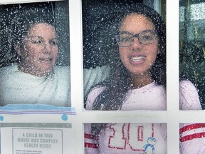 Lisa Ali and her 15-year-old daughter Tahlia look out from the front door of their Halifax-area home in Cole Harbour, N.S., on March 24, 2020. The teenaged girl who set out on a 1,800-kilometre RV trip with her grandmother and mother to seek her new lungs has received the life-changing operation amid an era of COVID-related delays.