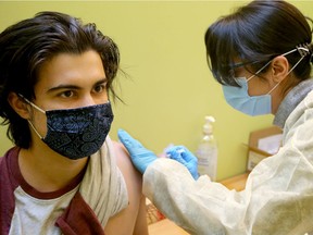 Pharmacist Sara Azad administers a flu shot to Matt Kranabetter at Brisson Pharmacy in downtown Ottawa on Nov. 2, 2020.