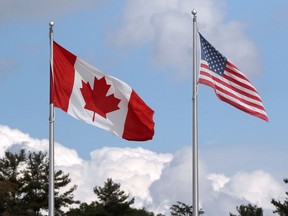 A Canadian and American flag flutter at the Canada-United States border crossing at the Thousand Islands Bridge, which remains closed to non-essential traffic to combat the spread of the coronavirus. Among other challenges, the two nations must eventually agree on when it is safe to reopen the border to normal traffic.