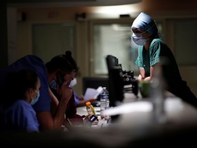 Medical staff members work in the Intensive Care Unit (ICU) where patients suffering from the coronavirus disease (COVID-19) are treated at the Melun-Senart hospital, near Paris, France, November 20, 2020.