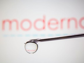 Moderna's logo is reflected in a drop.