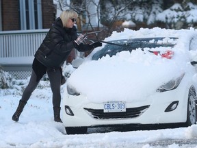 OTTAWA -   Residents of Ottawa clean up some overnight snow in Ottawa Monday Nov 23, 2020.