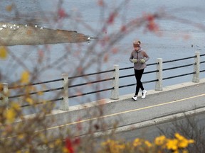 A woman jogs along the Rideau Canal.