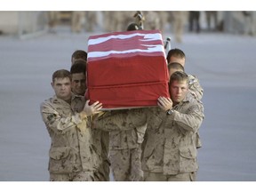 Kandahar, Afghanistan, 2008:     Pallbearers carry the remains of Sgt Prescott Shipway between formed ranks to a waiting CC-130 Hercules aircraft during the ramp ceremony at Kandahar Airfield, Afghanistan. Sgt Shipway was an infantrymen with the Second Battalion, Princess Patricia's Canadian Light Infantry.