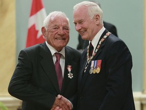 David Johnston (right), then the governor general, awards former hockey player Howie Meeker the Order of Canada during an awards ceremony in Ottawa at Rideau Hall May 27, 2011.