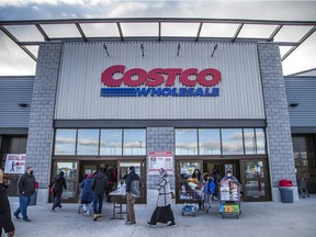Shoppers head into and out of the Costco Gloucester location on Saturday, Nov. 21, 2020.