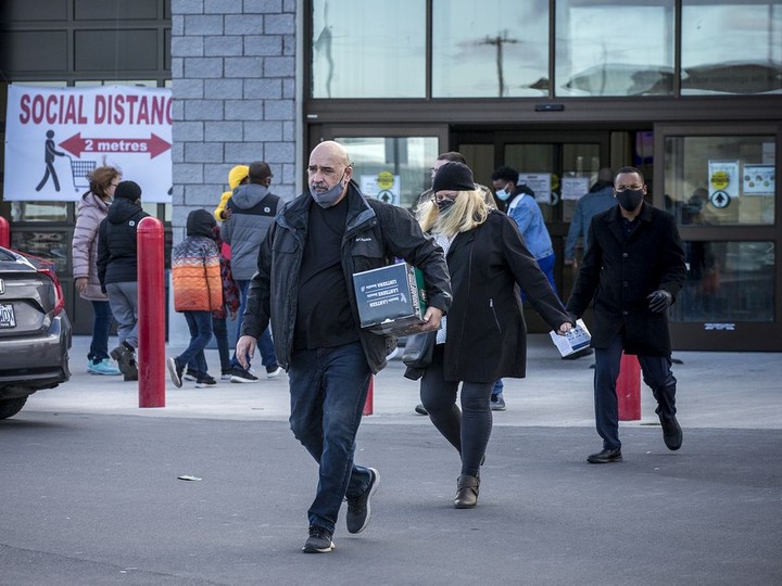  Shoppers head into and out of the Costco Gloucester location on Saturday, Nov. 21, 2020.