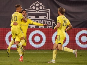 Nashville SC forward Daniel Rios (14) reacts with teammates after scoring against Toronto FC during the second half of extra time in the Eastern Conference play-in round at Hartford on Tuesday night.