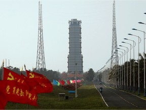 Flags with Chinese Communist Party's emblem flutter along a road leading to a launch tower with the Long March-5 Y5 rocket inside before its launch, at Wenchang Space Launch Center in Hainan Province, China November 23, 2020.