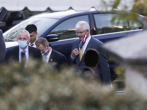 Michigan State Senate Majority Leader Mike Shirkey adjusts his protective face mask as he arrives to meet with U.S. President Donald Trump at the White House in Washington, U.S., November 20, 2020.