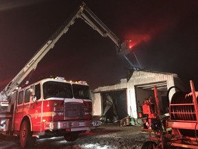 Ottawa Fire Services crews battle a fire in an agricultural storage building on York's Corners Rd., east of Metcalfe, on Thursday evening.