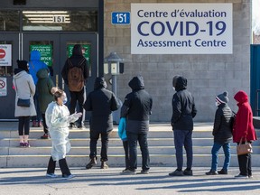 A file photo shows people lining up at the COVID-19 Assessment Centre at Brewer Park arena.