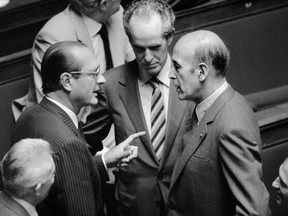 (FILES) This file photo taken on Oct. 2, 1984 shows Jacques Chirac (L), talking with Valery Giscard d'Estaing (R) as Claude Labbe (C) looks on in Paris, at the French Assembly.