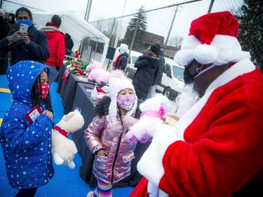 A couple of eager youngsters make their pitch to Santa Claus at the Rideau Sports Club during Saturday's event.