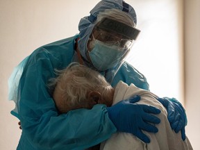 Dr. Joseph Varon hugs and comforts a patient in the COVID-19 intensive care unit (ICU) during Thanksgiving at the United Memorial Medical Center on November 26, 2020 in Houston, Texas. According to reports, Texas has reached over 1,220,000 cases, including over 21,500 deaths.