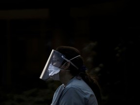 FILE: A nurse wears protective clothing.