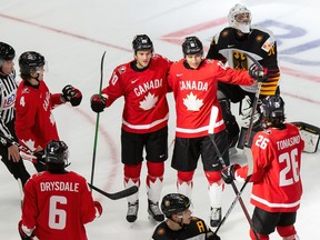 Bowen Byram (4), Dawson Mercer (20), Ryan Suzuki (16) and Philip Tomasino (26) of Canada celebrate a goal against goaltender Jonas Gahr (30) of Germany during the 2021 IIHF world junior championships at Rogers Place on Dec. 26, 2020 in Edmonton, Canada.