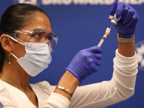 A nurse prepares a Moderna vaccination for a Florida frontline worker.
