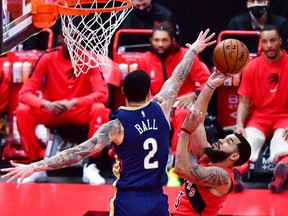 The Pelicans' Lonzo Ball blocks a shot by the Raptors' Fred VanVleet during the first quarter of Wednesday's game at Tampa, Fla.