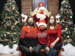 Richard Johansson, 8, and his grandmother Lynda, left, and mother, Kristin, pose for photos with Santa Claus at the Billings Bridge Mall on Tuesday.