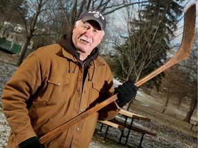 Wayne Caruk holds his hockey stick, which likely dates back to between 1870 and 1900.