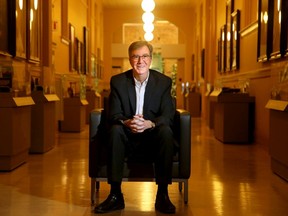 Mayor Jim Watson, photographed in the long hallway adorned with portraits of previous mayors at Ottawa City Hall.