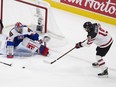 Canada's Quinton Byfield (19) tries to pass the puck in front of Slovakia's goalie Samuel Hlavaj (29) during second period IIHF World Junior Hockey Championship action on Sunday, Dec. 27, 2020 in Edmonton.