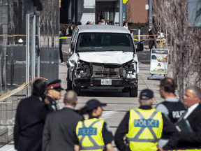 The van driven by Alek Minassian in a deadly rampage sits on a sidewalk in Toronto on Monday, April 24, 2018.