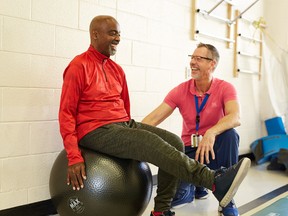 Fran Cosper with Andrew Atkinson, physiotherapist assistant, in the gym of The Ottawa Hospital Rehab Centre.
