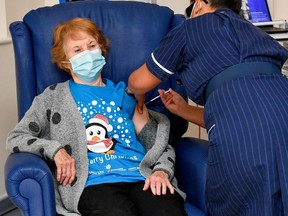 Margaret Keenan, 90, is the first patient in Britain to receive the Pfizer/BioNtech COVID-19 vaccine at University Hospital, administered by nurse May Parsons, at the start of the largest ever immunization programme in the British history, in Coventry, Britain December 8, 2020.