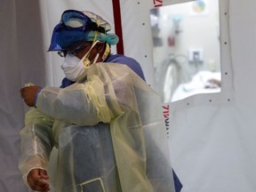 FILE: A nurse puts on PPE.