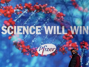 A person walks past the Pfizer Headquarters building in New York City, New York, U.S., December 7, 2020.