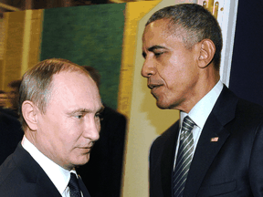 Russian President Vladimir Putin with U.S. President Barack Obama during a UN conference on climate change, November 30, 2015. About two weeks later, Obama said the U.S. would retaliate after the White House accused Putin of direct involvement in cyberattacks designed to influence the U.S. election.