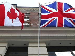Files: The Canadian flag flies alongside the British flag outside an Ottawa hotel Sept 26, 2012.