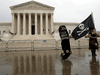 Protesters claiming voter fraud against President Donald Trump stand outside of the U.S. Supreme Court in Washington, U.S., Nov. 11, 2020.