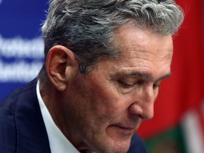Premier Brian Pallister reacts during a press briefing at the Manitoba Legislative Building in Winnipeg on Tues., Nov. 24, 2020.