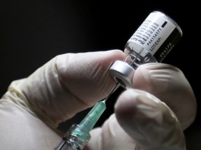FILE: A healthcare worker prepares to administer a Pfizer/BioNTEch coronavirus disease (Covid-19) vaccine.