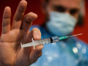 FILE: A member of the medical staff prepares a dose of the Pfizer/BioNtech COVID-19 vaccine.