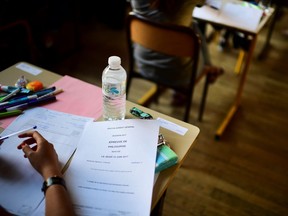 Young people take part in a written test in philosophy as part of the Baccalaureat (France's high school diploma) at a school in Paris.