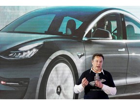 FILE PHOTO: FILE PHOTO: Tesla Inc CEO Elon Musk speaks onstage during a delivery event for Tesla China-made Model 3 cars at its factory in Shanghai, China January 7, 2020.