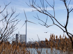 A wind turbine is seen at the Pickering Nuclear Power Generating Station near Toronto. Canada needs to do more.