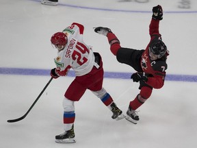 Canada's Kirby Dach is upended by Russia's Ilya Safonov during third period of Wednesday night's game in Edmonton. Dach left the game with an injury and his status for the world junior championship is in uncertain.
