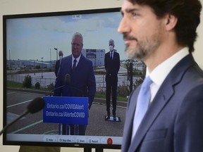 Prime Minister Justin Trudeau takes part in a press conference at the Ford Connectivity and Innovation Centre in Ottawa in October, joined virtually by Ontario Premier Doug Ford. For the most part, Canadians have supported their top politicians through the pandemic this year.