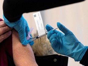 The Pfizer-BioNTech COVID-19 vaccine is administered to a personal support worker at the Civic campus of The Ottawa Hospital on Dec. 15.