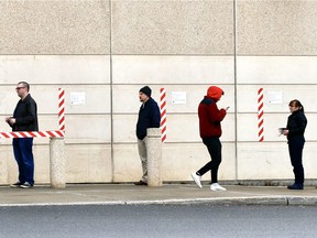 OTTAWA -- Thursday, Mar. 26, 2020 -- People line up following physical distancing protocols before entering a store during the COVID-19 pandemic.