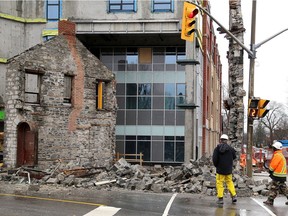 Officials from In8 Developments look through the rubble of bakery building in Kingston that dates back to the 1840s. It collapsed at approximately 4:30 a.m. on Friday, Dec. 25, 2020.
