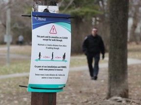 An Ottawa bylaw officer monitors the closure at Windsor Park in this file photo taken in early April.