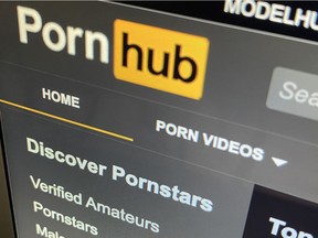 The Pornhub website is shown on a computer screen. The company is owned by Montreal-based Mindgeek.