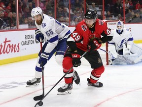FILE: Scott Sabourin battles with Braydon Coburn while goalie Curtis McElhinney looks on in the first period as the Ottawa Senators take on the Tampa Bay Lightning.