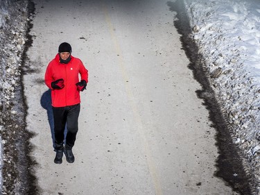 The bright sun helped to get people out and about, including this runner along the canal, on the chilly day Ottawa had Sunday Jan. 30, 2021.